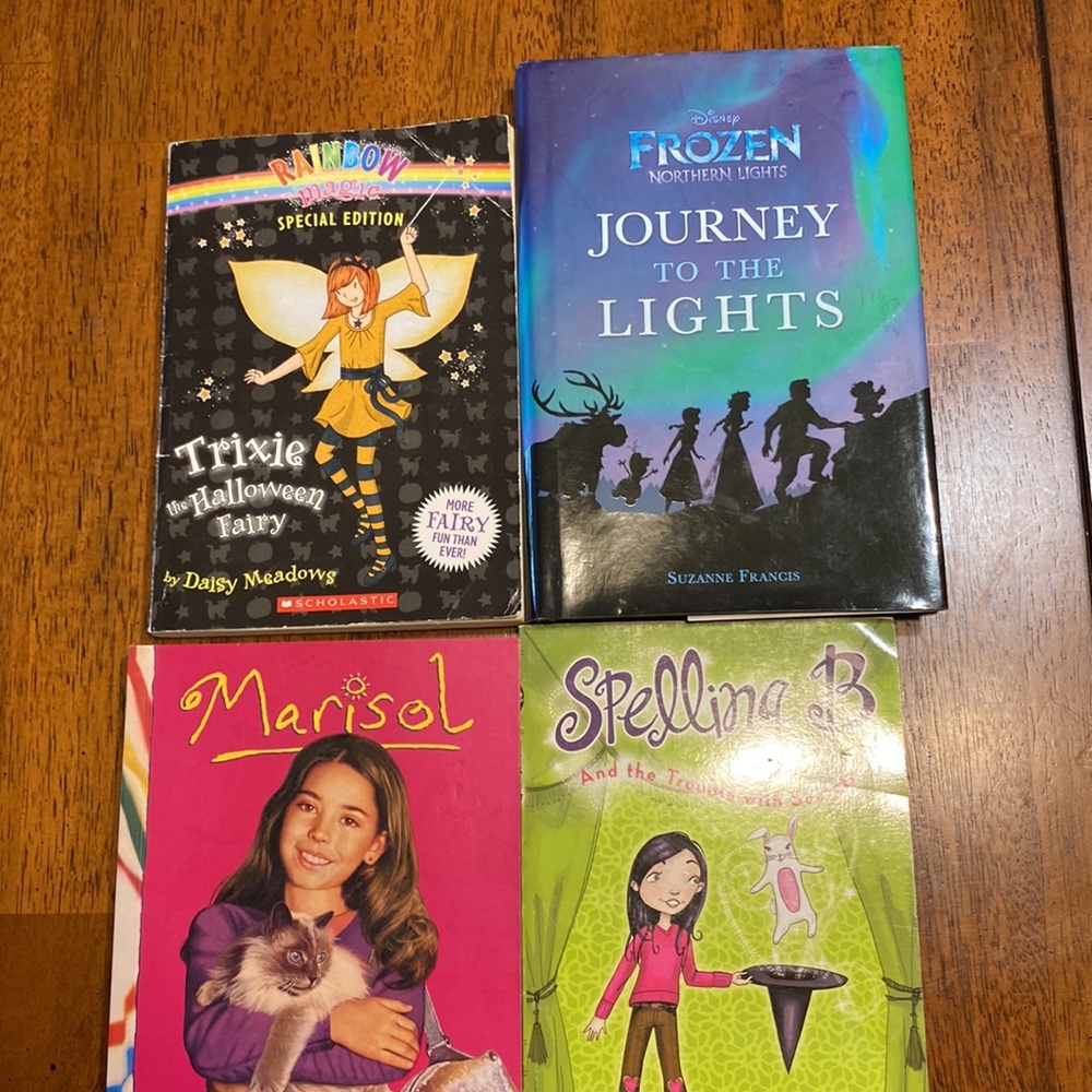 Four books. One frozen Disney hard back one American girl,  two Scholastic paper